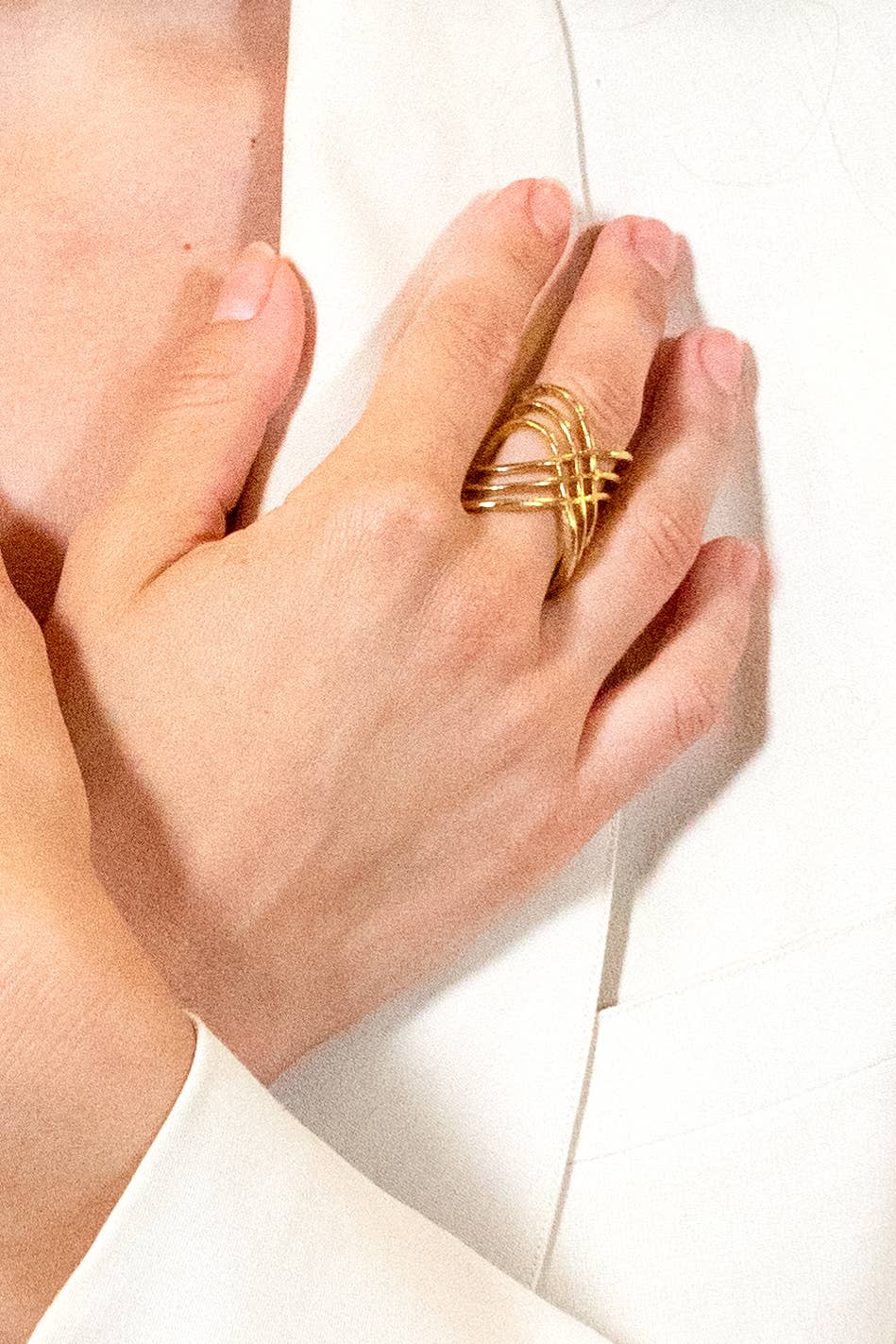 model is wearing a gold abstract ring