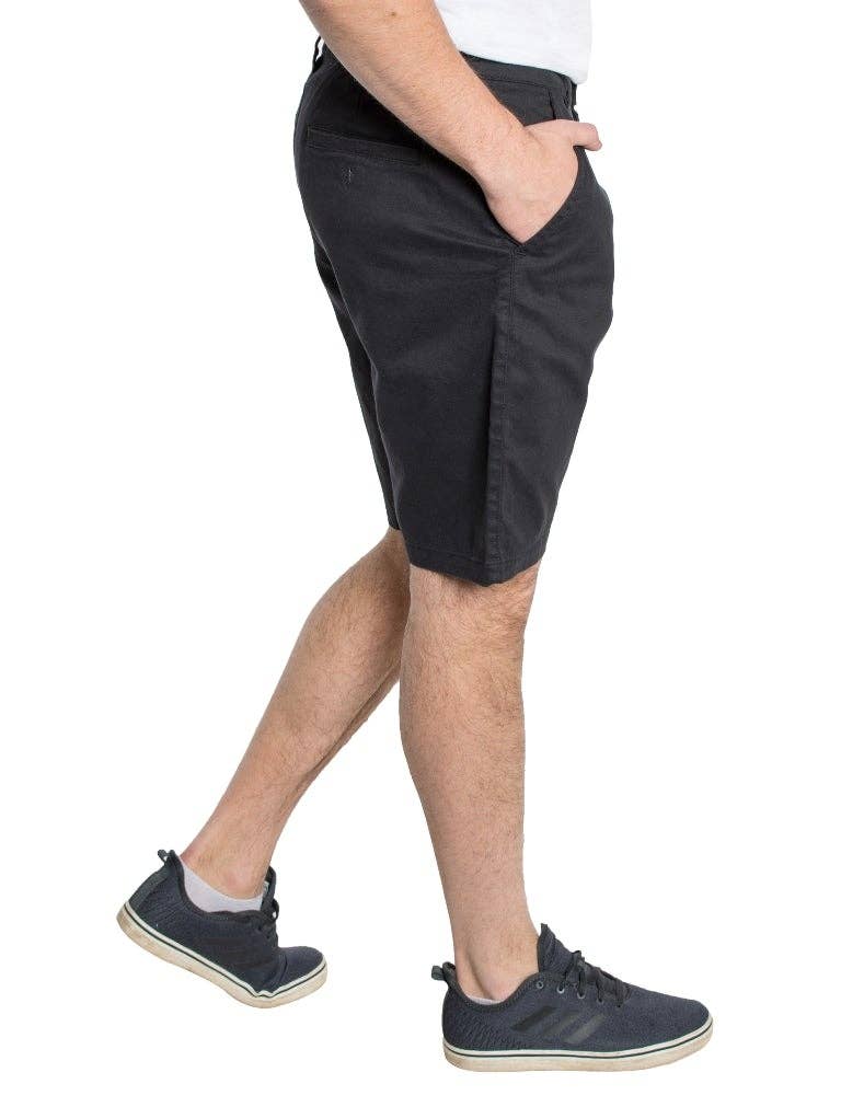 Male model wearing navy shorts with a grey tee and navy sneakers.