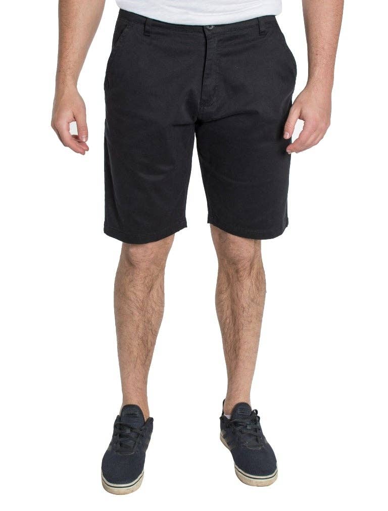 Male model wearing navy shorts with a grey tee and navy sneakers.