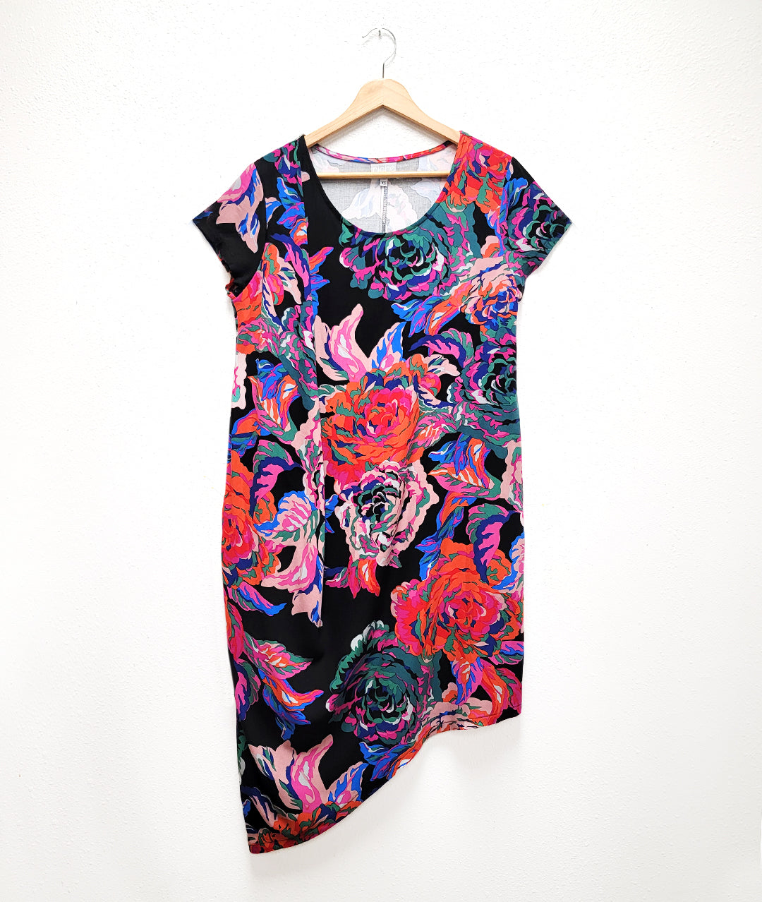 floral print dress with an asymmetrical drape on one shoulder, and an asymmetrical hem