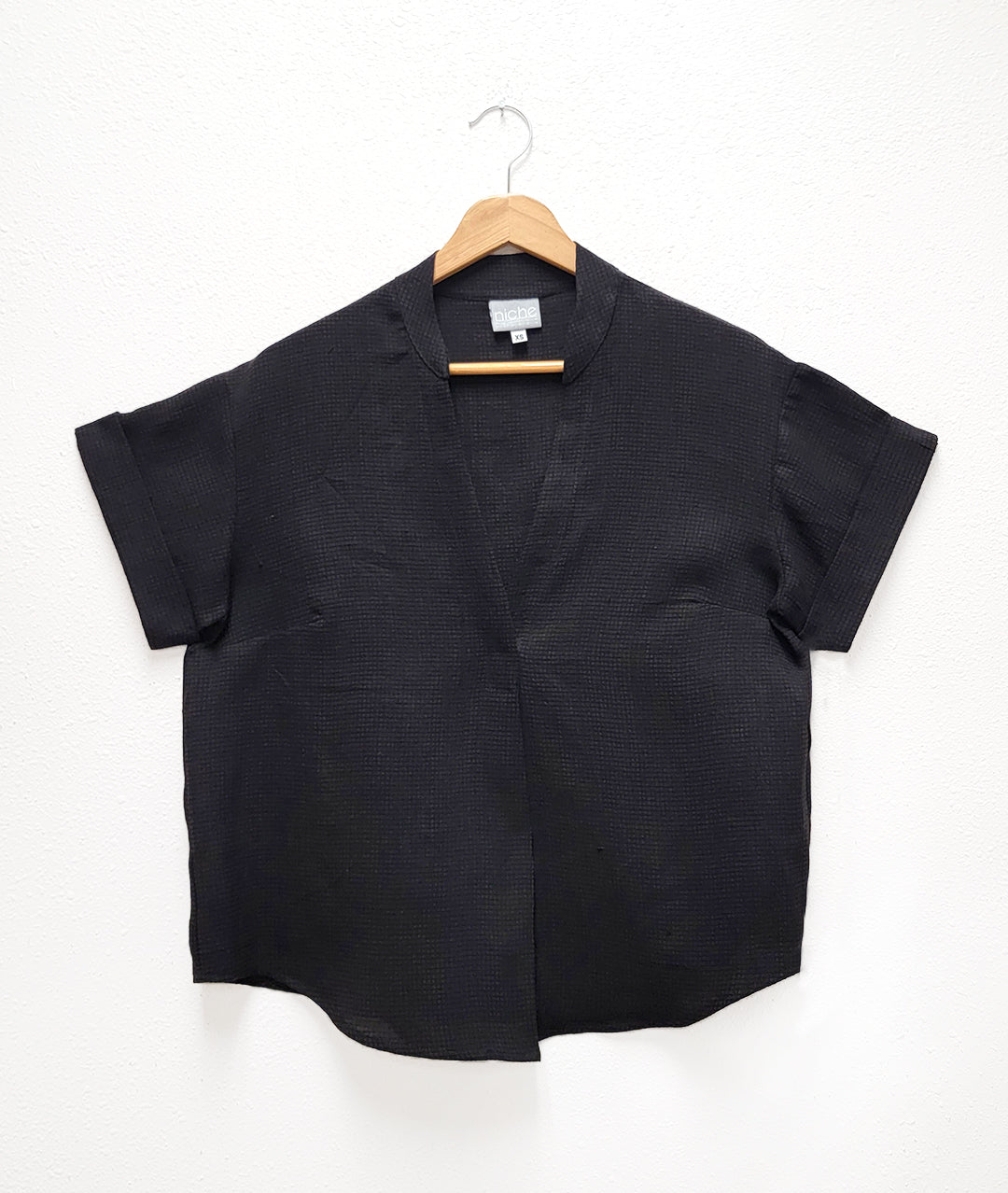 black linen blend top on a light background