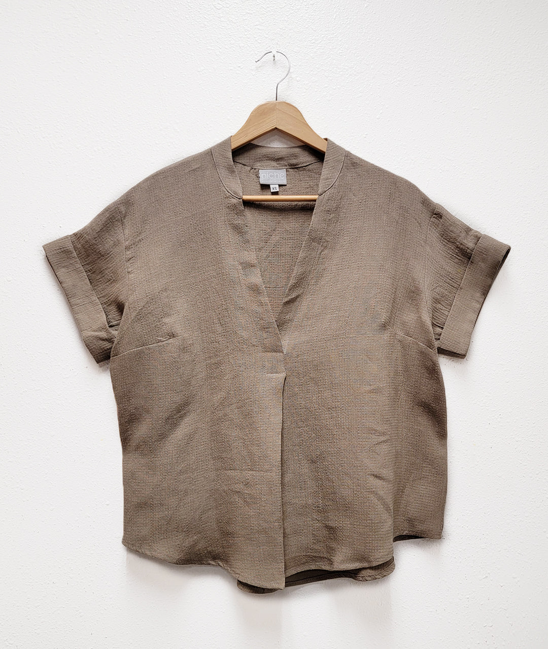 taupe linen blend top on a light background