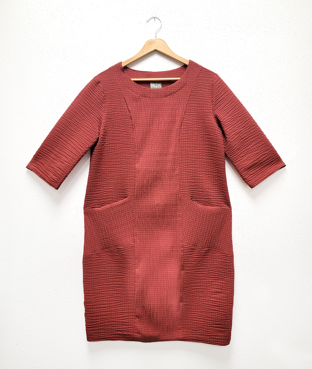 rust color shift dress with princess seams and a pocket at either hip