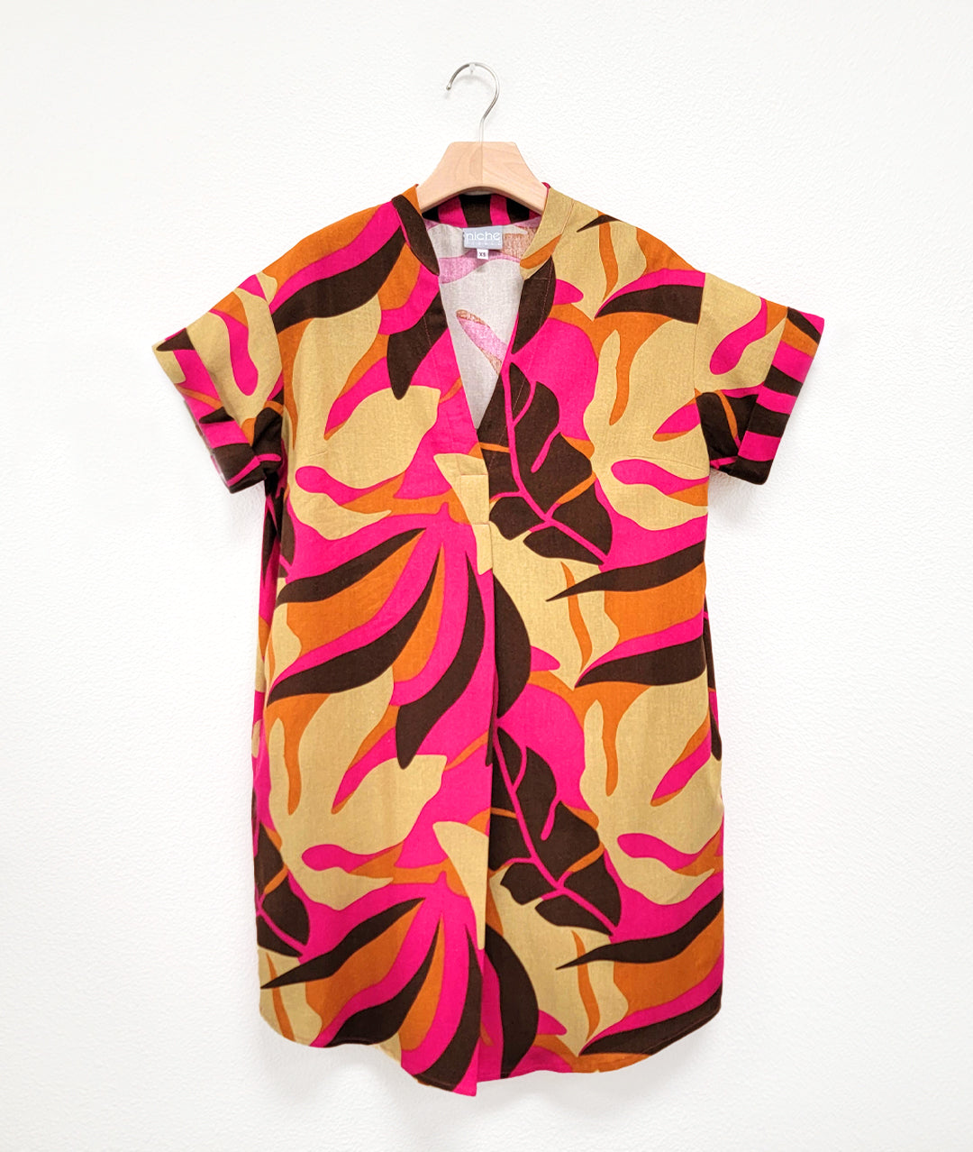multicolor leaf print boxy pull over dress with a v-neck, short cuffed sleeves, and a rounded hemline