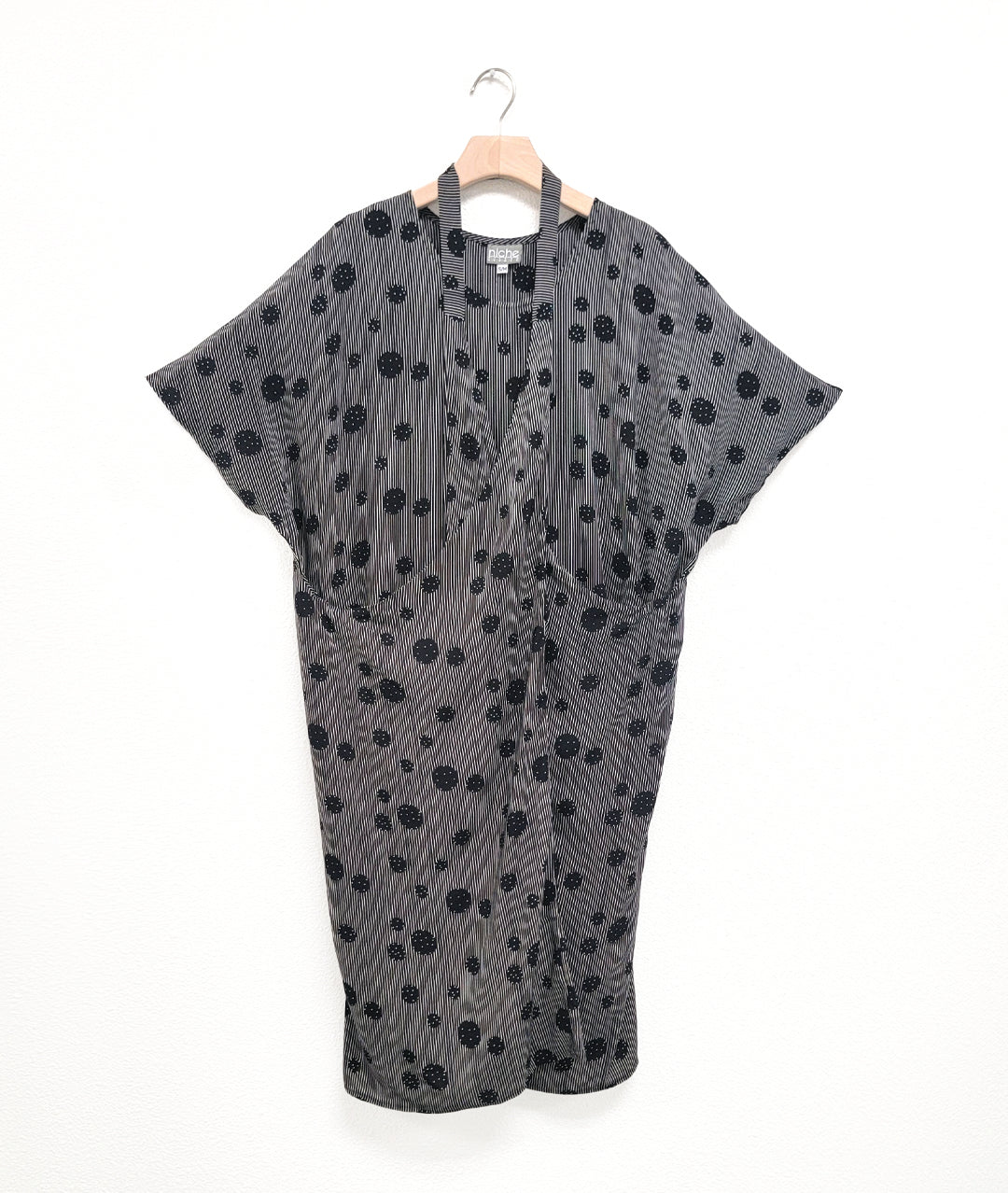 black and white stripe tunic with a black dot print circle design. dress has a strap from the hips worn around the neck