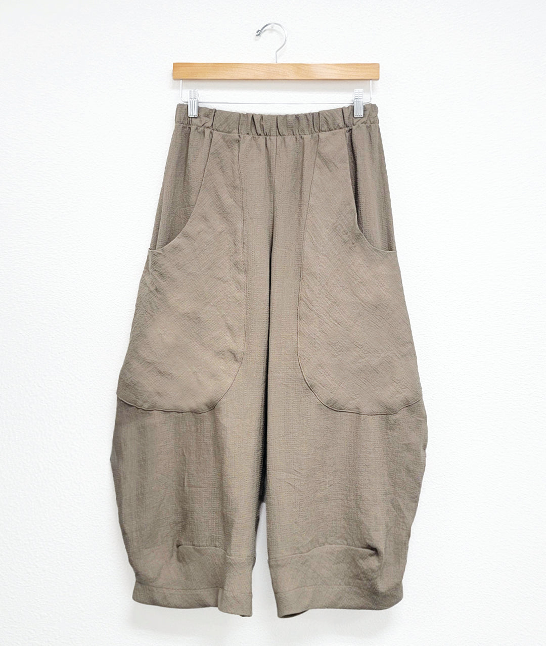 taupe color mini grid print wide leg pant with a tapered ankle, oversized exterior pockets, and an elastic waistband