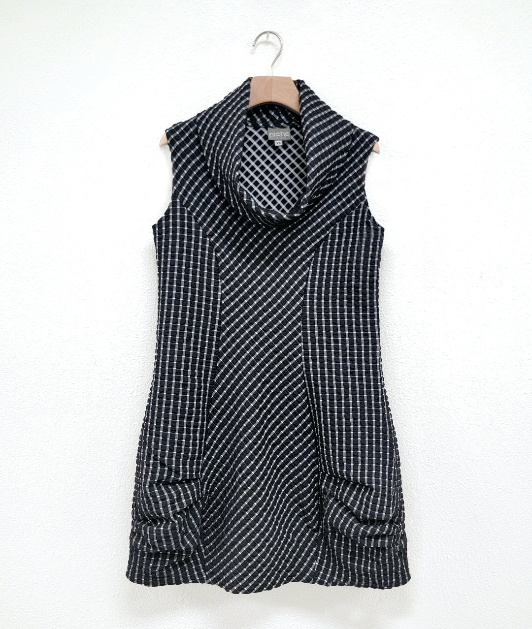 black and white grid print tunic with a cowl neck, princess seams, pockets and a pleating detail at the hips