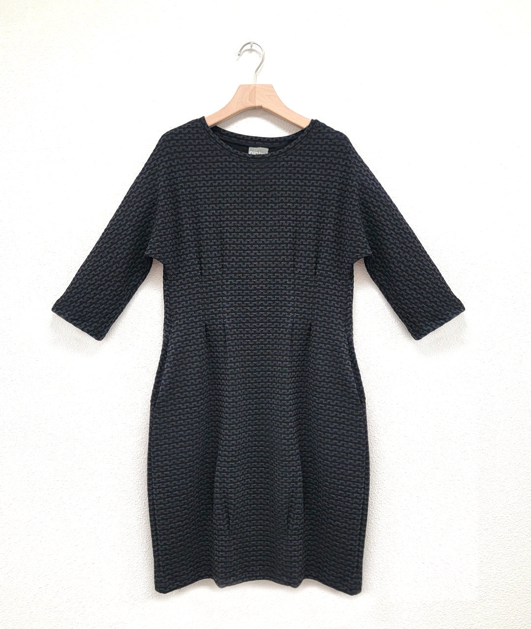 black and grey zipper print knit dress with 3/4 sleeves, pockets and shaping darts at the waist
