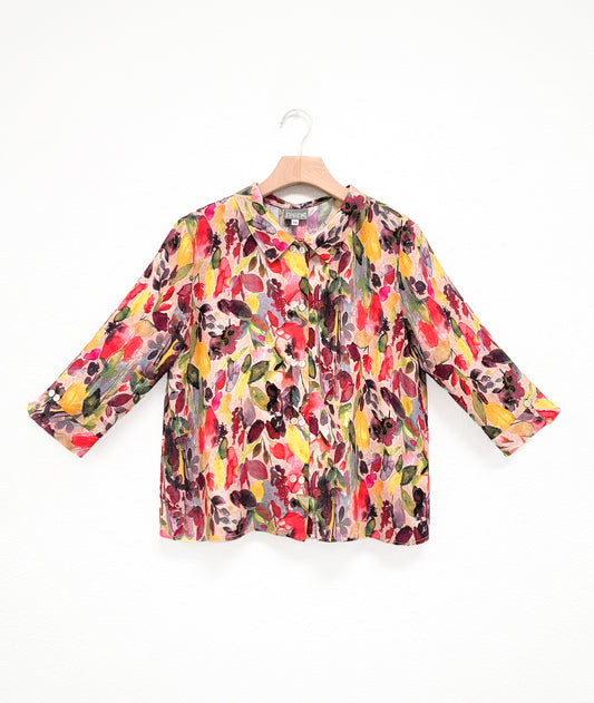 multi color button down blouse with a boxy body, 3/4 sleeves, and a twin button detail at the sleeves, back and front