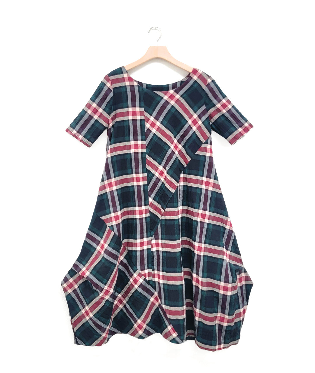 red and green plaid dress with contrasting panels and tucks on the sides