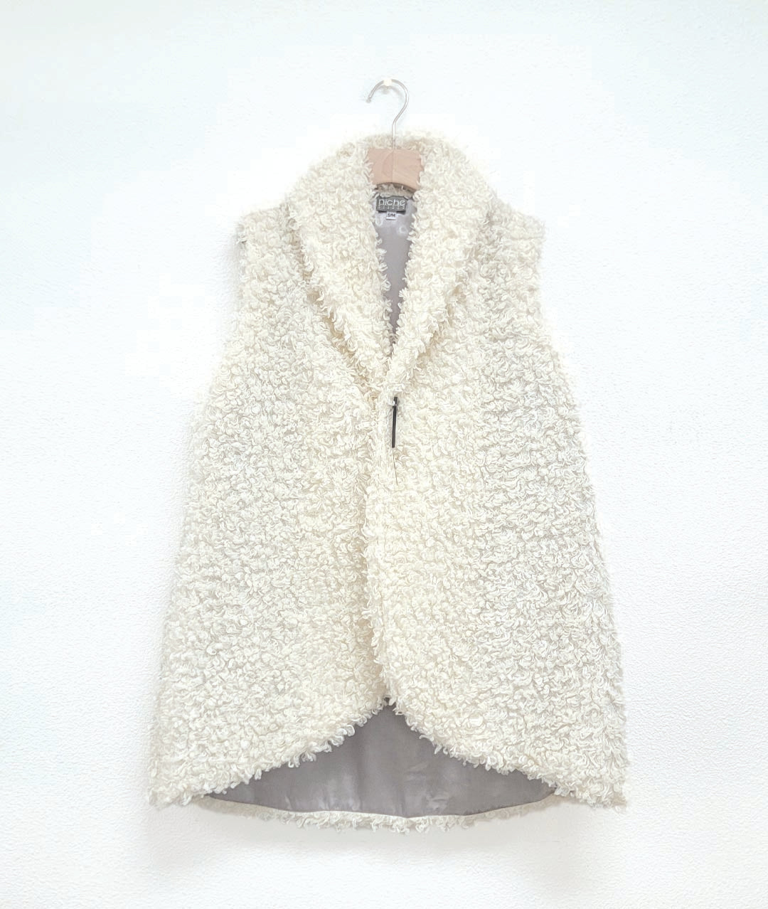 short white faux fur vests with a kilt pin closure and a silver lining