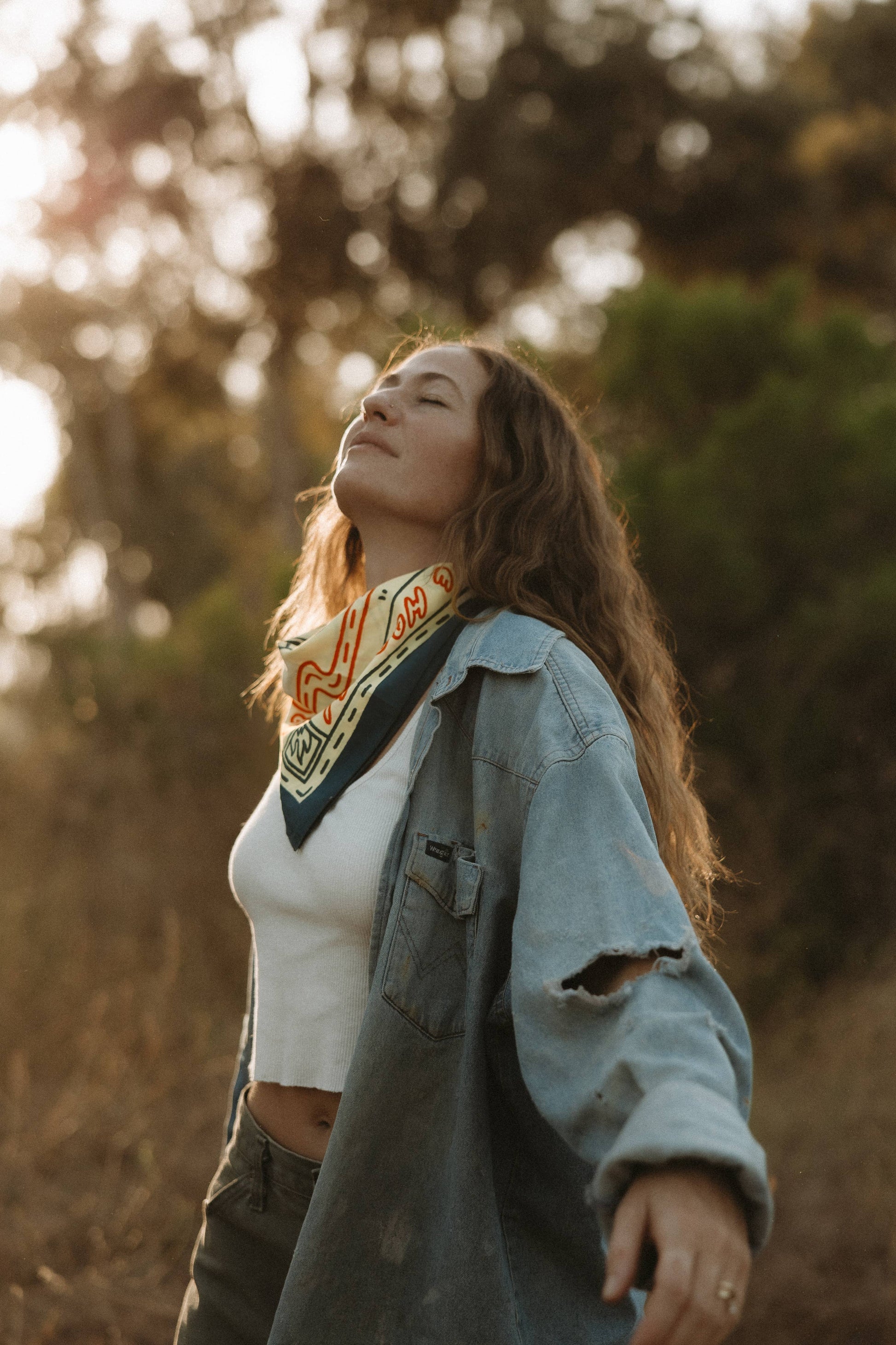 women wearing bandana around neck, white shirt and jean jacket