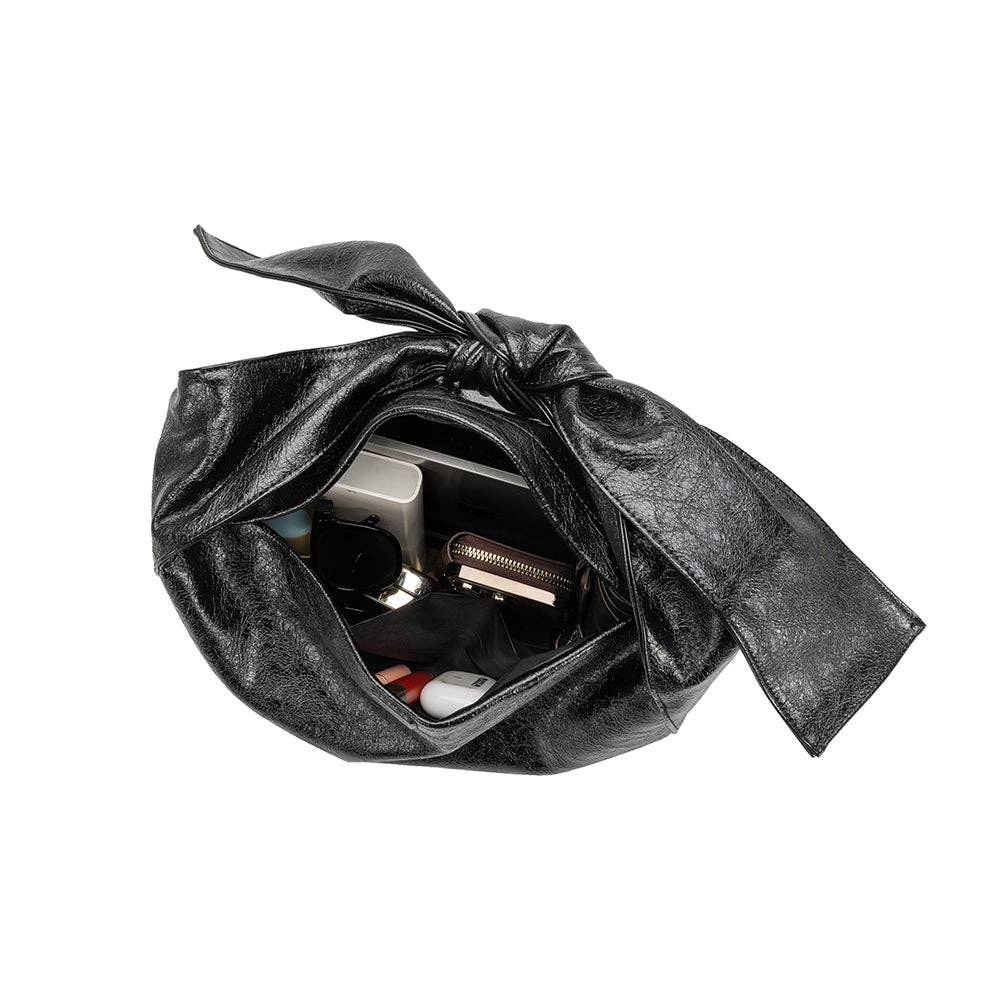 inside view of black handbag with a bow strap on a white background