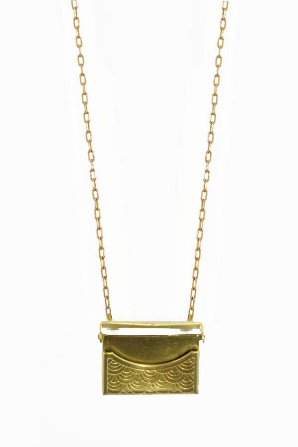 A gold-colored brass envelope locket necklace opened