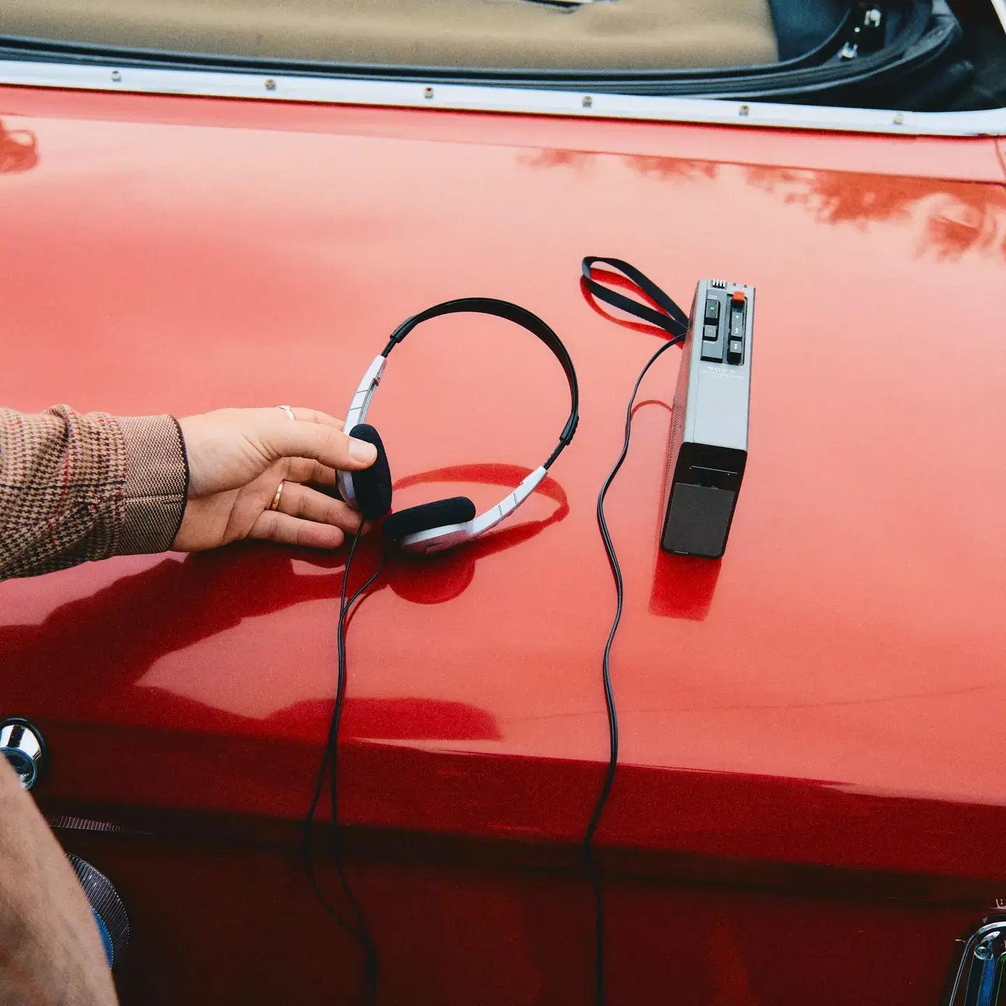 someone holding headphones and music player