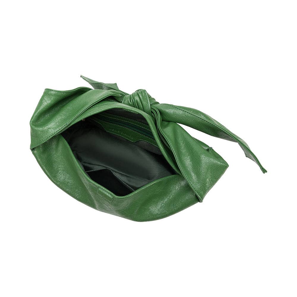 inside view of green handbag with a bow strap on a white background