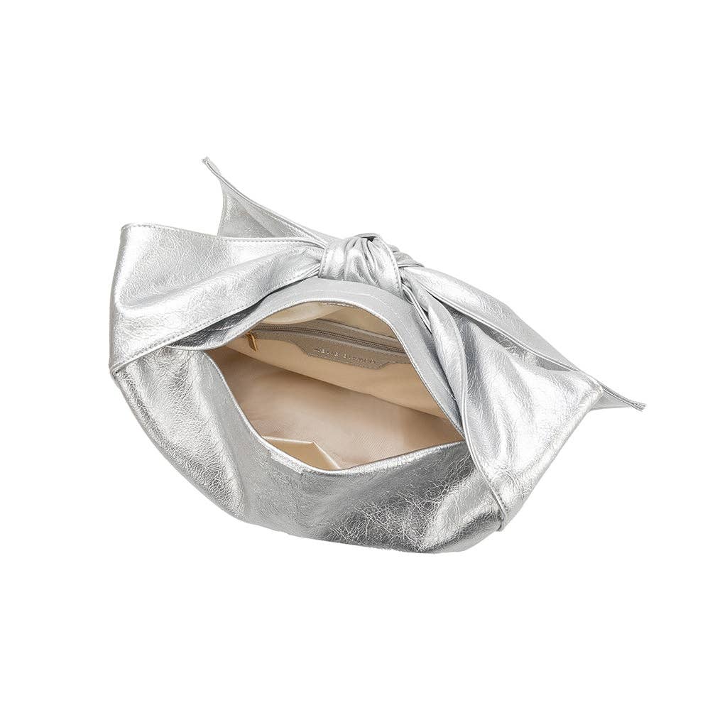 inside view of silver handbag with a bow as the strap on a white background