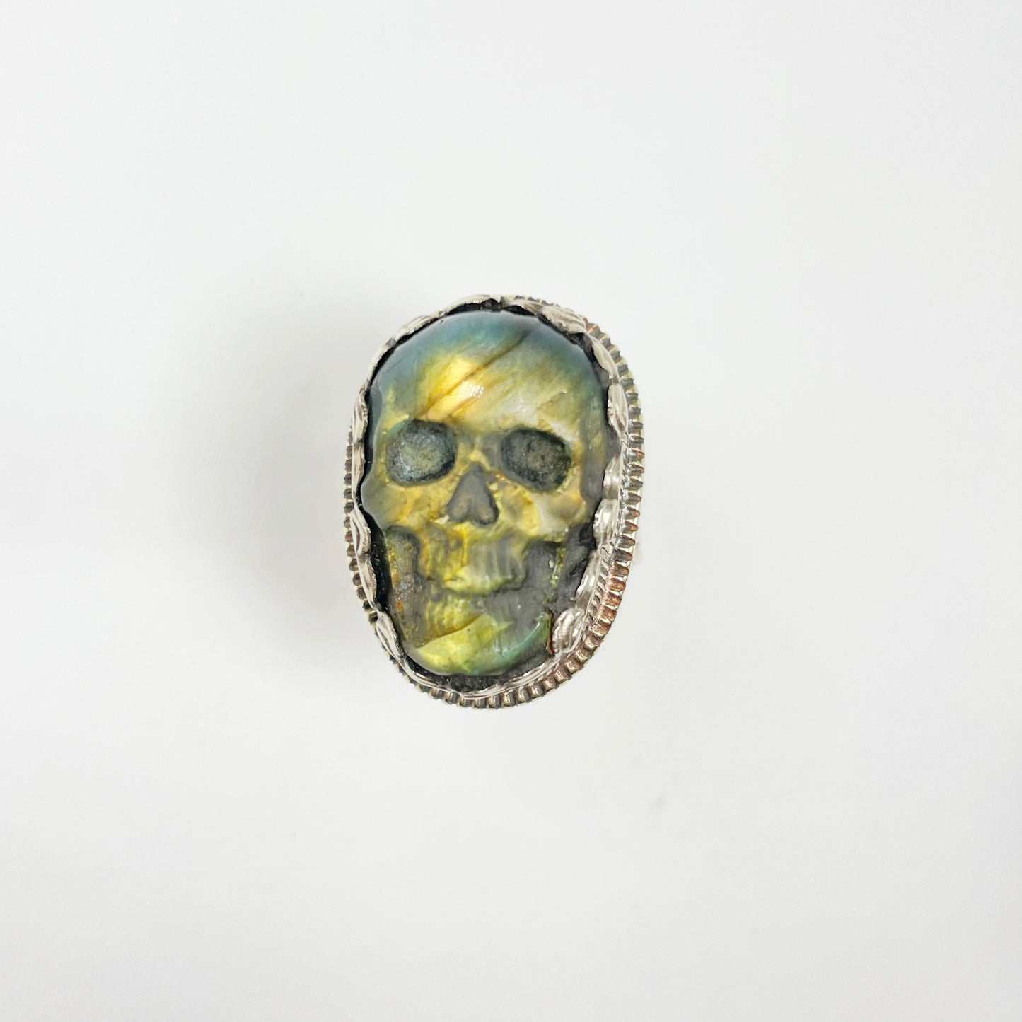 kull carved Green Labradorite set in detailed Tibetan Silver ring against white background