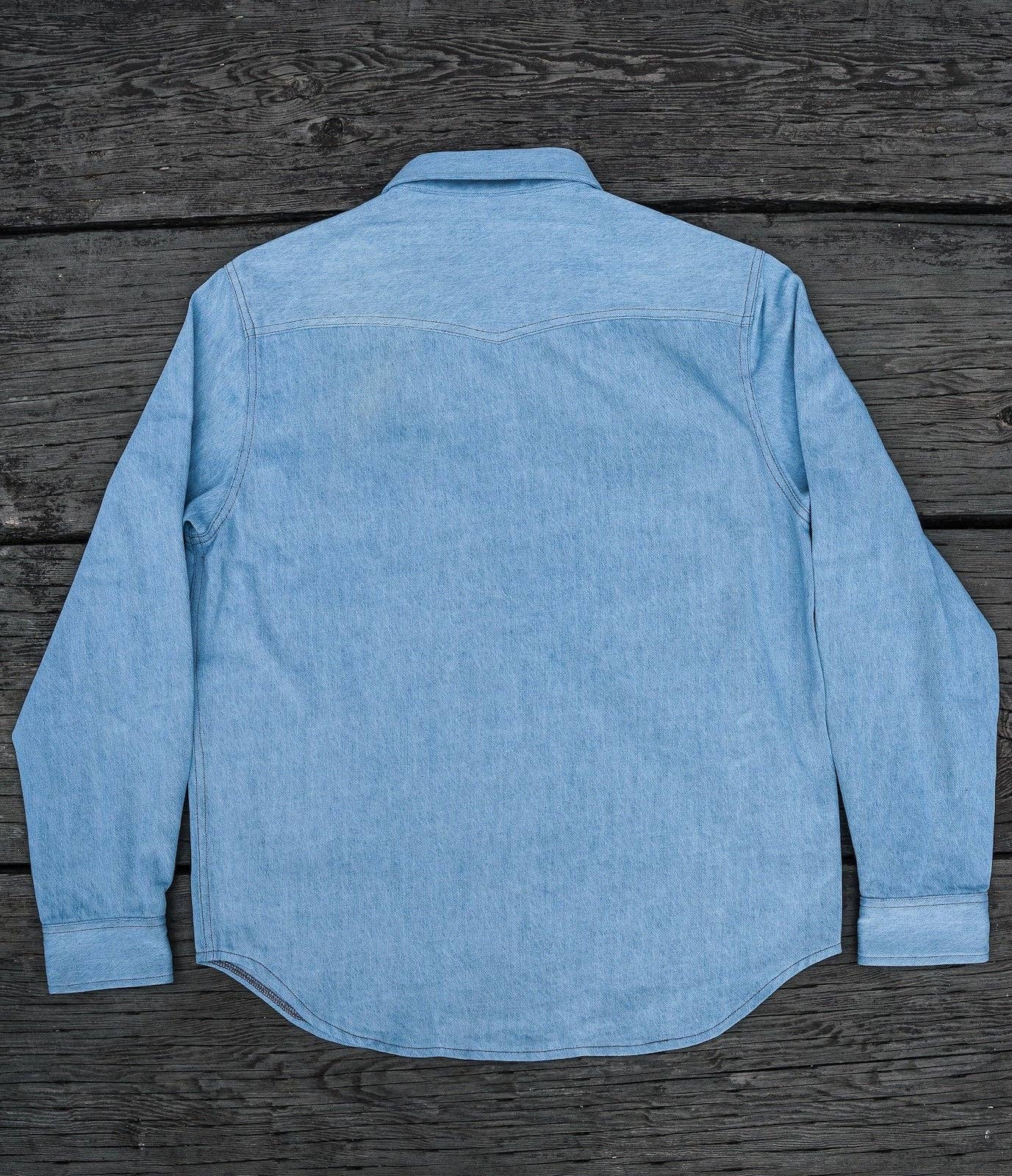 Light blue denim shirt on a wooden surface