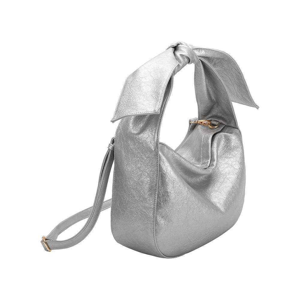 Silver handbag with a bow as the shoulder strap, featuring longer crossbody strap on a white background