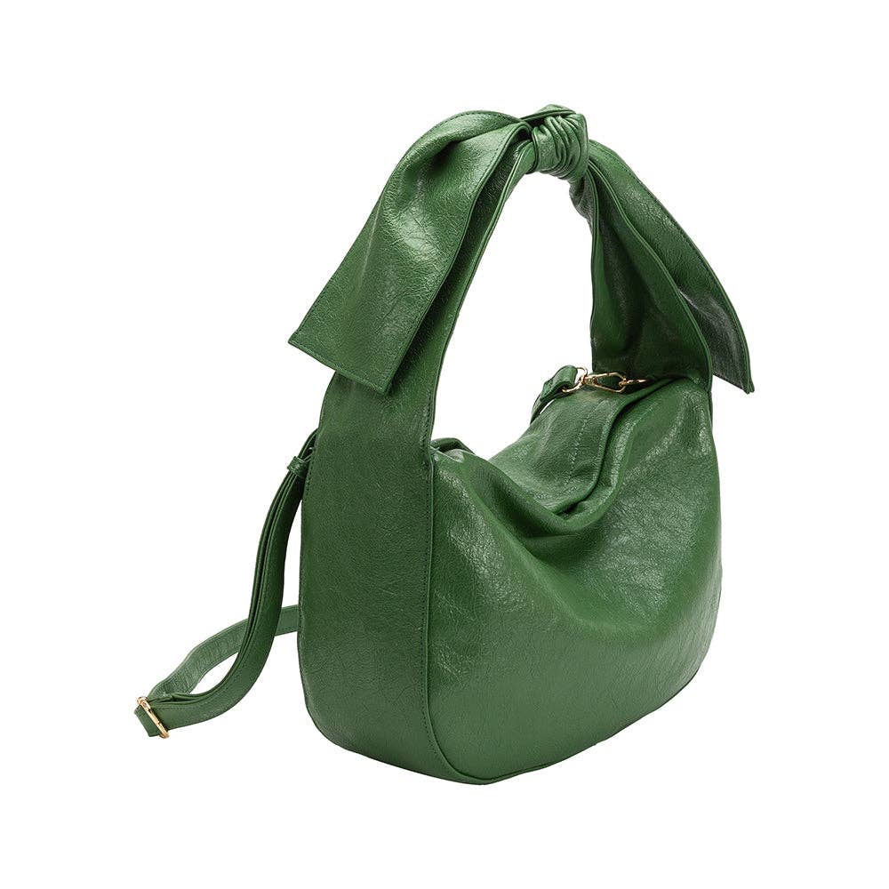 Green handbag with a bow strap detail and attached crossbody strap on a white background