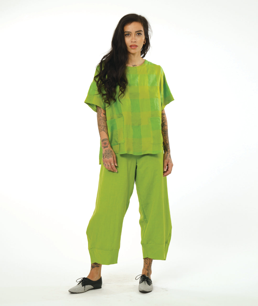 model in a wide lime green pant with a tapered ankle, worn with a matching plaid pullover basic, with hip pockets and a lower back hem