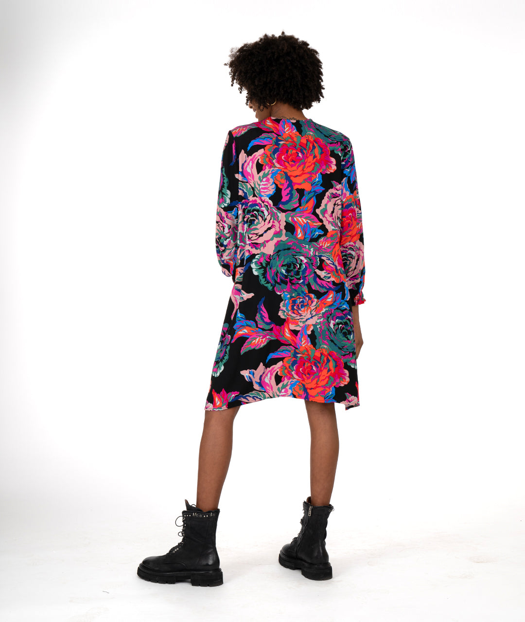 model in a floral print A-line shape dress has a plunging v-neck, gathers at the waist, elastic in the cuffs