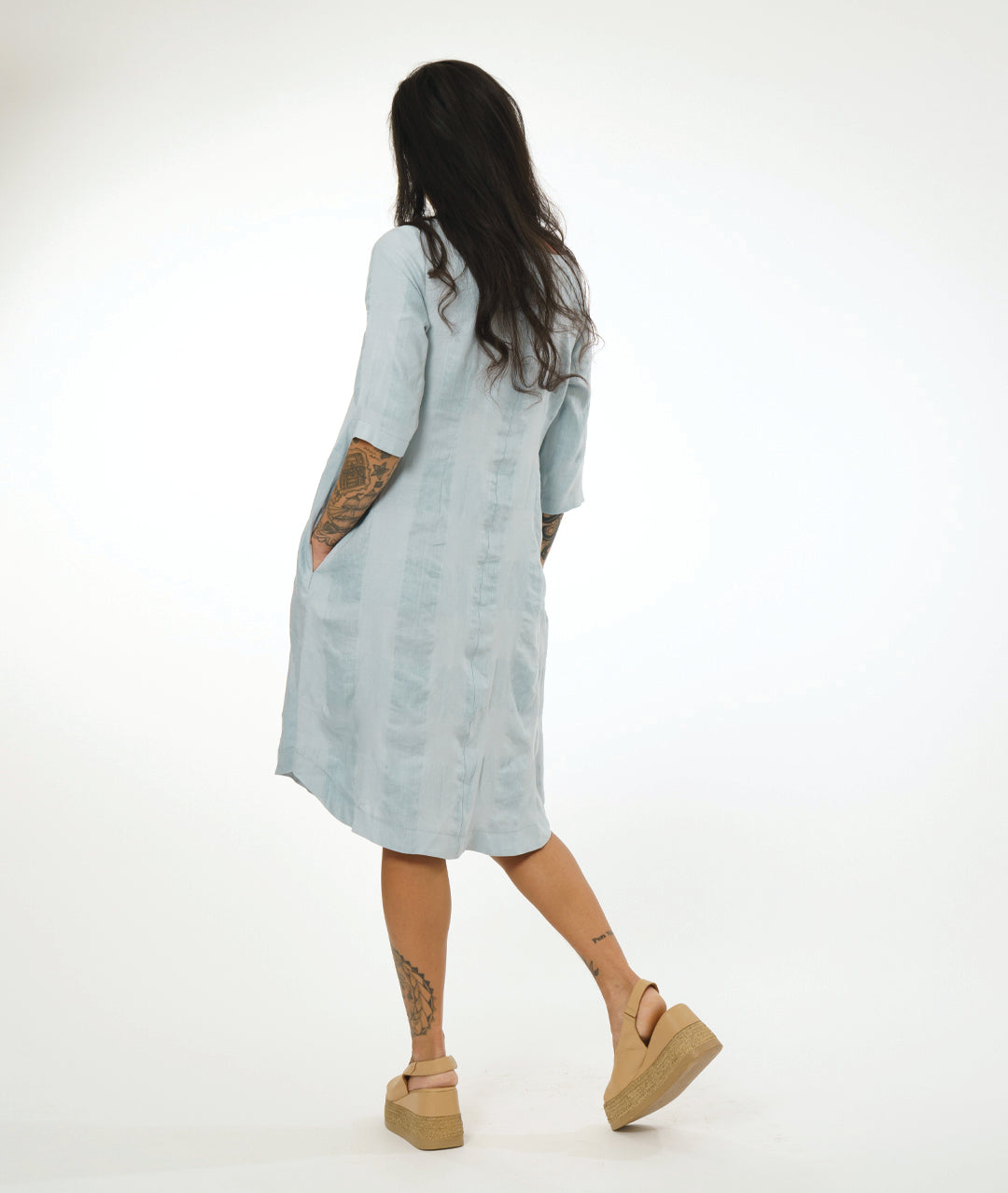 model in a silvery blue extra large check print pullover dress with a rounded neckline, elbow length sleeves and a rounded hemline