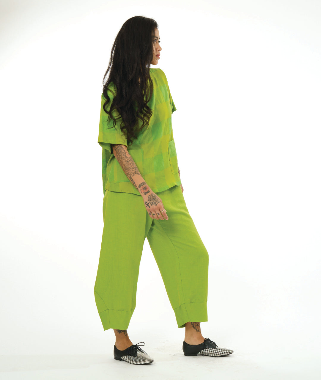 model in a wide lime green pant with a tapered ankle, worn with a matching plaid pullover basic, with hip pockets and a lower back hem
