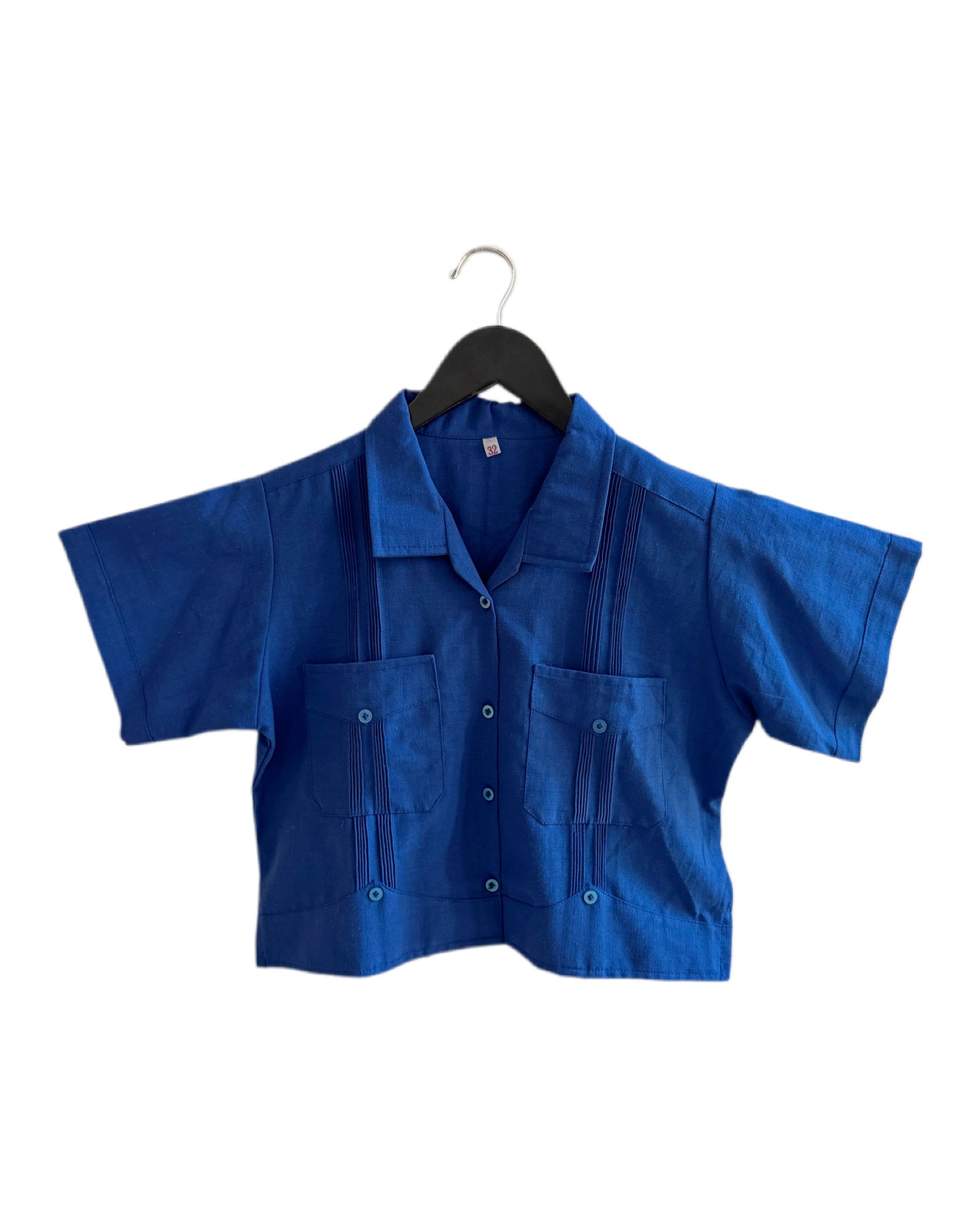 Blue shirt on a hanger against a white background