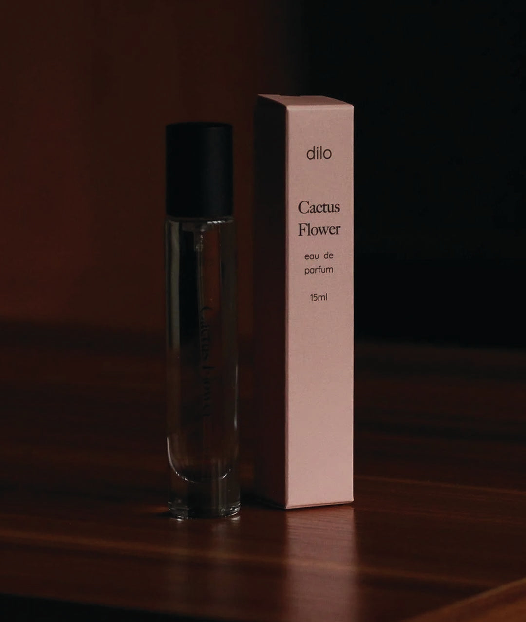 cactus flower scented perfume bottle with packaging on wood table