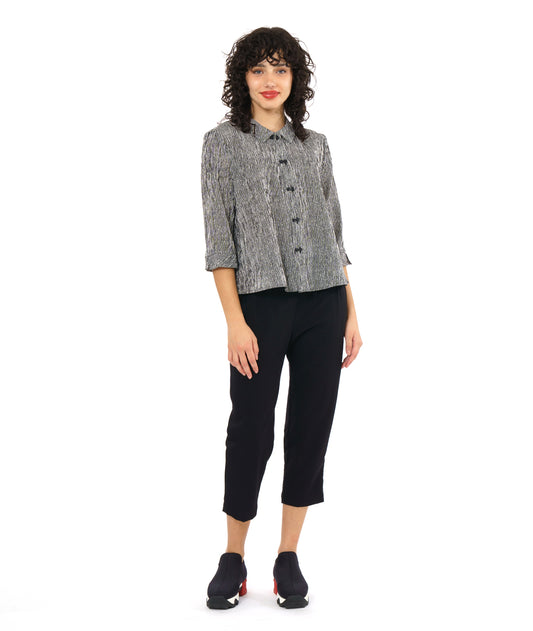 model in a straight leg black pant with a black and white stripe button down blouse with a black twin button down the placket, 3/4 sleeves and a boxy body