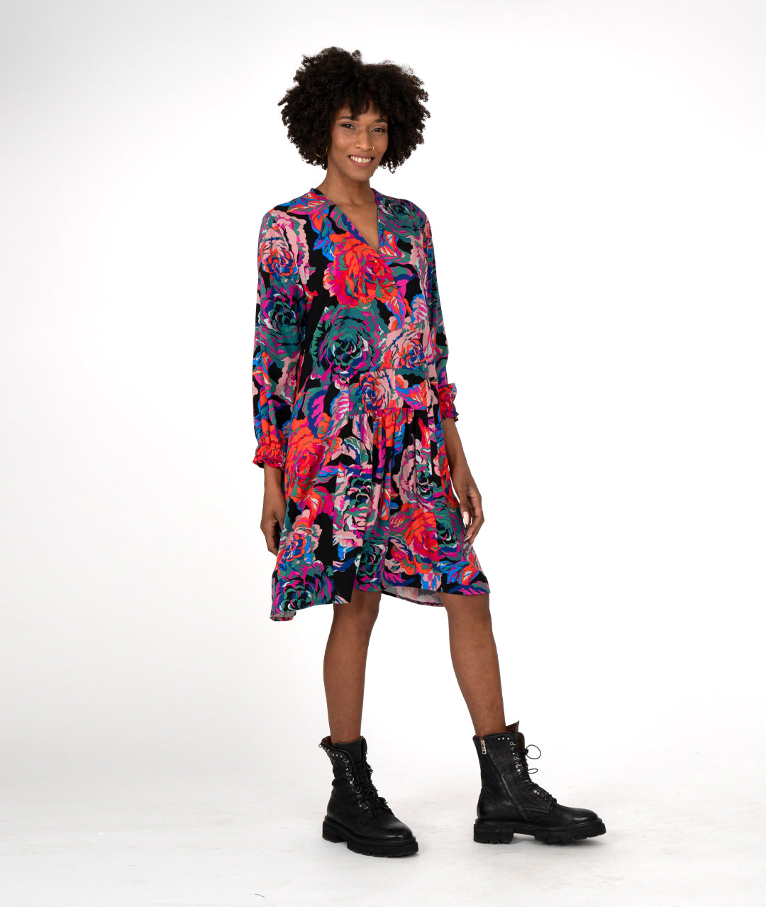 model in a floral print A-line shape dress has a plunging v-neck, gathers at the waist, elastic in the cuffs