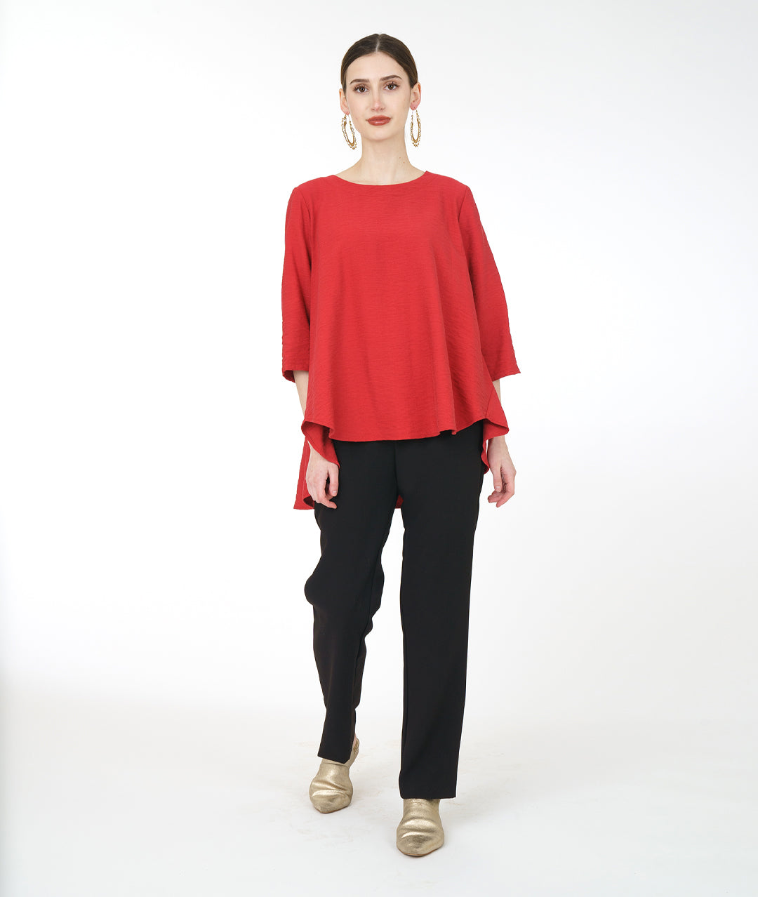 model in a slim black pant with a red pullover top with 3/4 sleeves and a swingy back