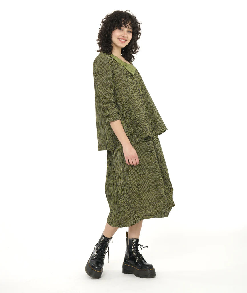 model wearing green striped top with contrasting collar and green striped skirt