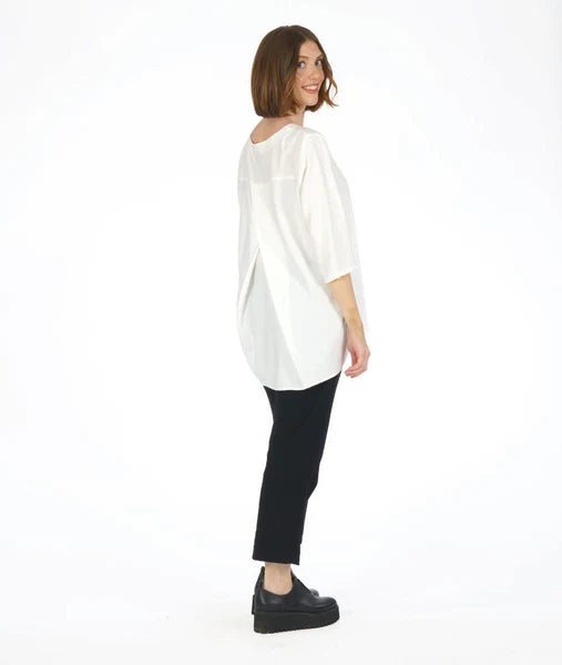 model wearing 3/4 sleeve white top with black slim leg pants with slit at the ankle