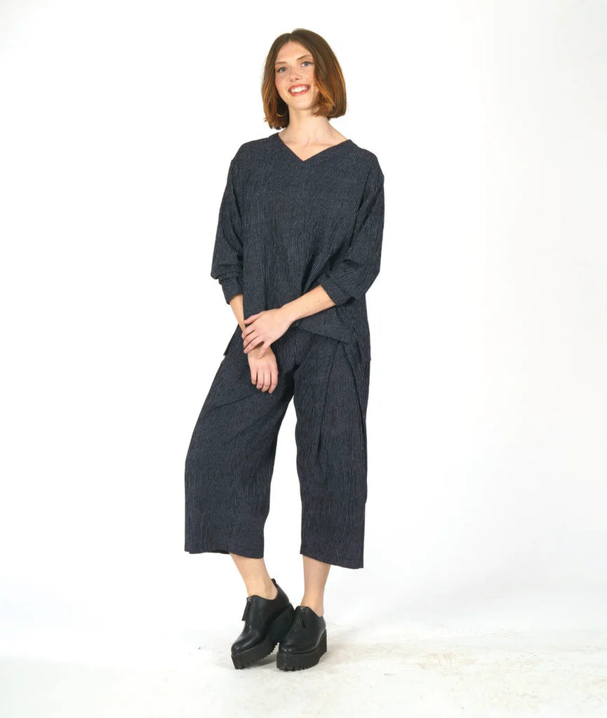 Woman wearing a dark grey outfit on a white background