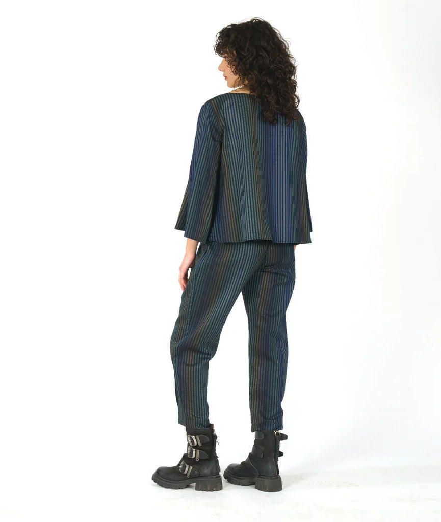 model showing back of dark blue striped outfit with black boots on a white background