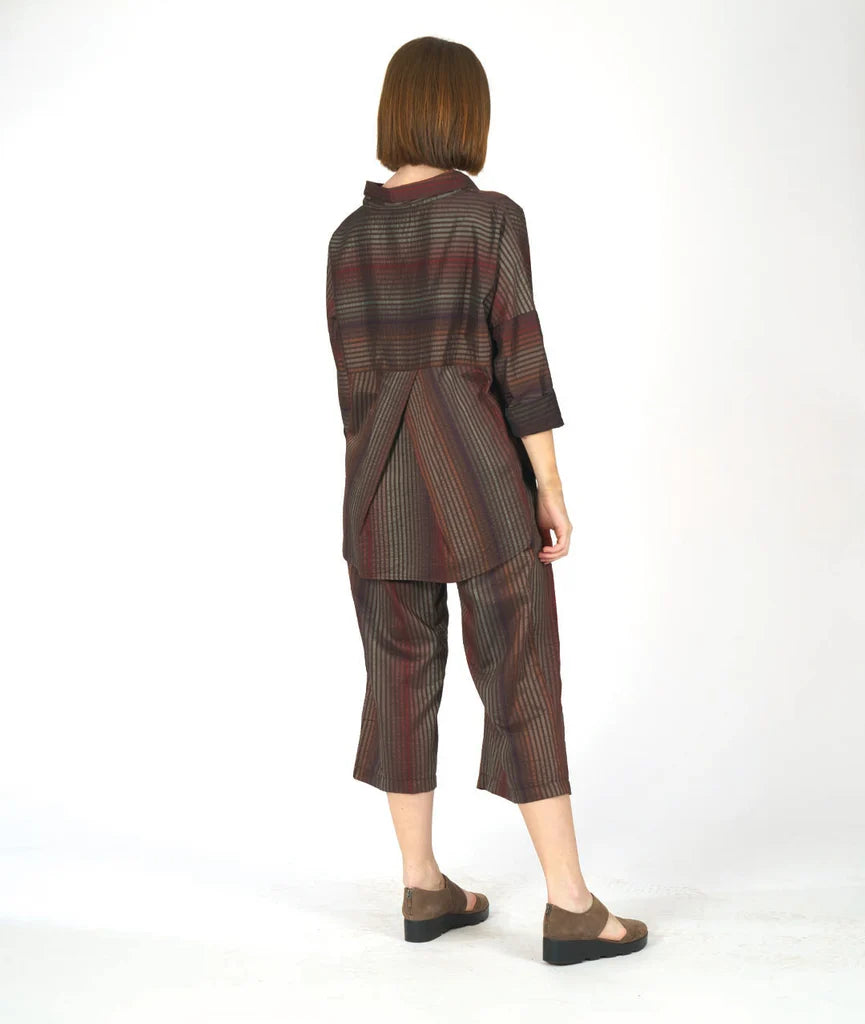 model showing back of striped top with pleated back on a white background