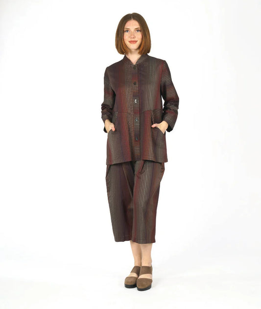 model wearing a brown striped button up long sleeve top and matching pants on a white background