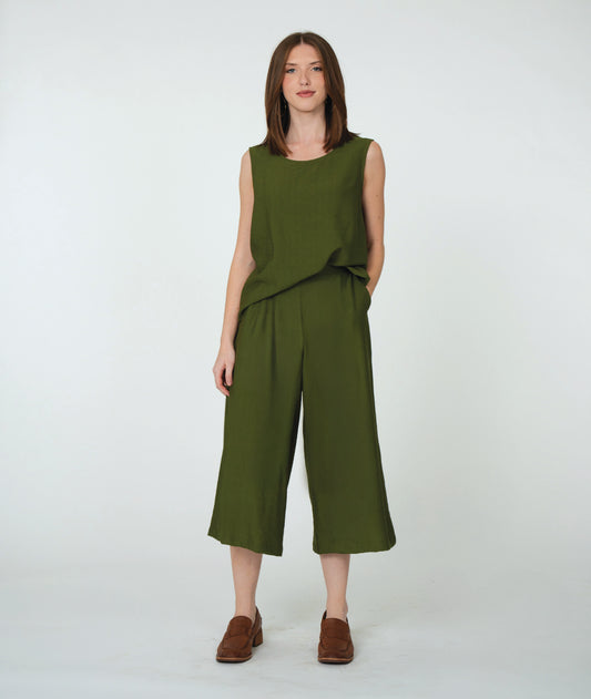model in a pine green wide leg pant with a pleated flat front, worn with a matching sleeveless top