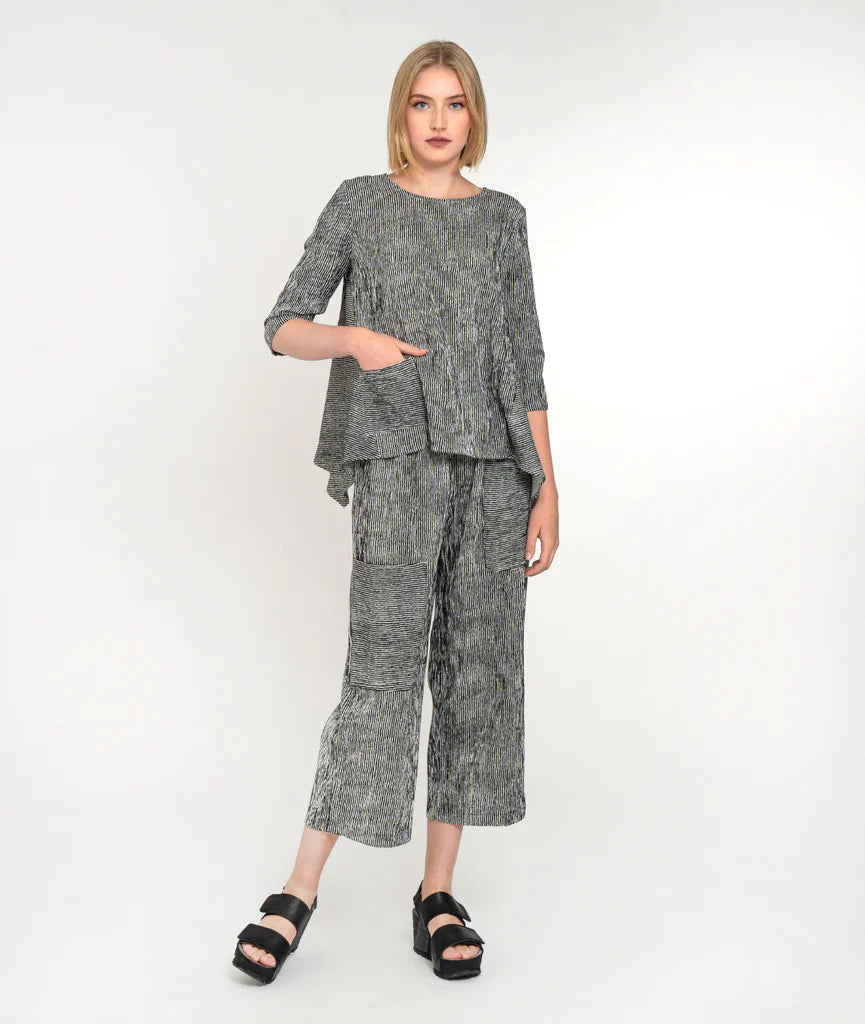 model wearing striped shirt and striped pants with asymmetrical pockets