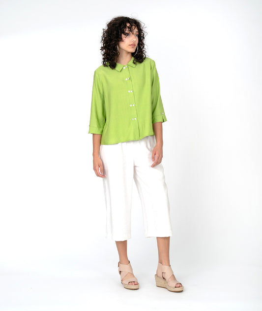 model in a white straight leg pant, worn with a pink button down blouse with a twin button detail and 3/4 sleeves