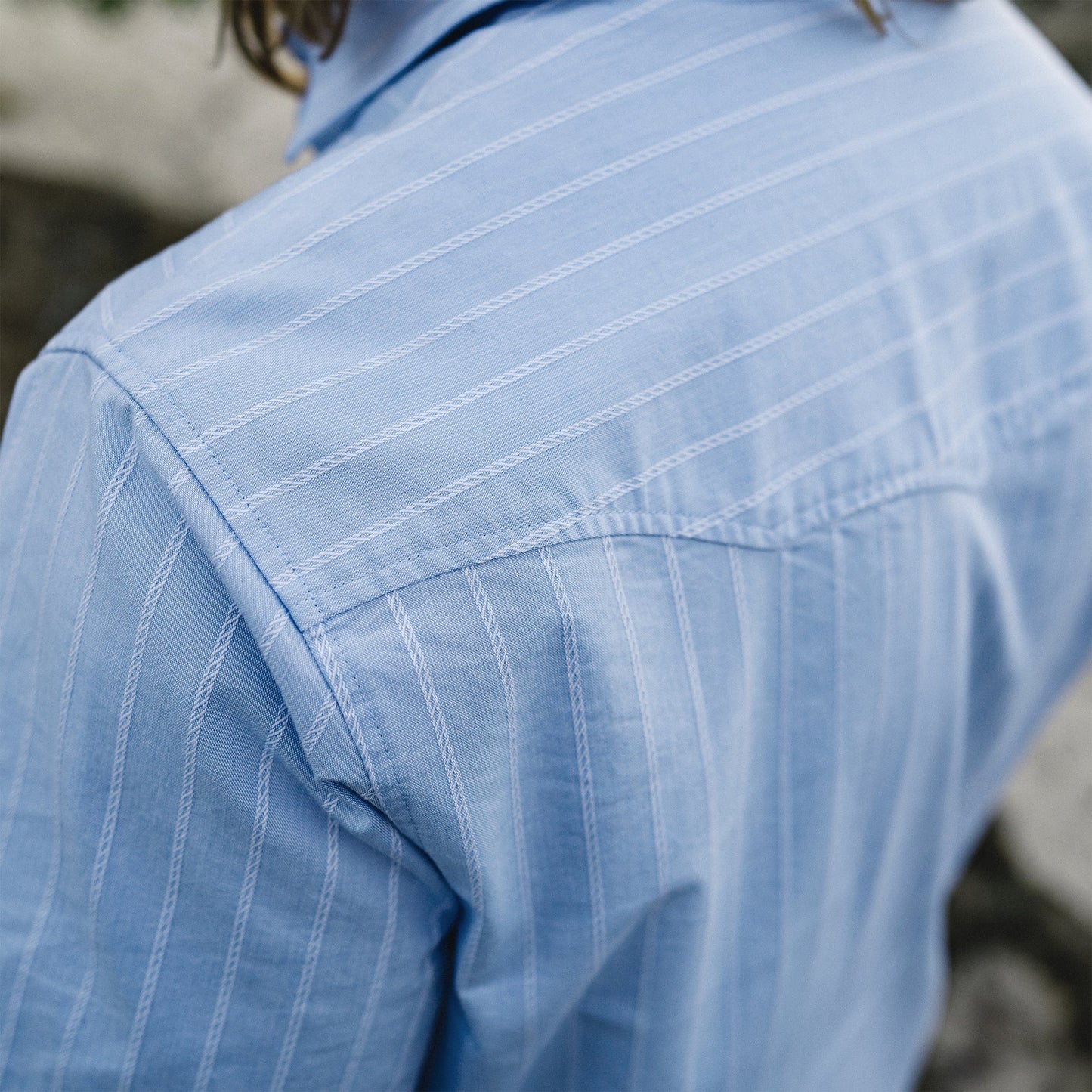 close up blue shirt with stripe pattern on a model
