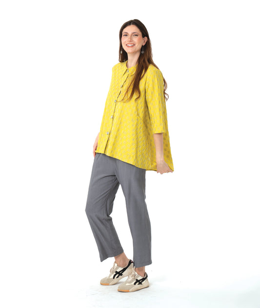 model in a yellow two tone checker board print button down blouse with 3/4 sleeves and a full body. worn with a slim grey pant