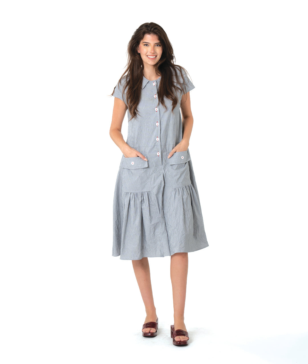 grey and white pinstriped button down dress with a dropped waist, cap sleeves, squared hip pockets and contrasted red stitching at the buttons.