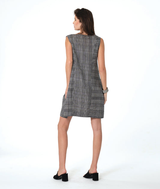 model in a black, white and grey plaid sleeveless shift dress with a squared collar