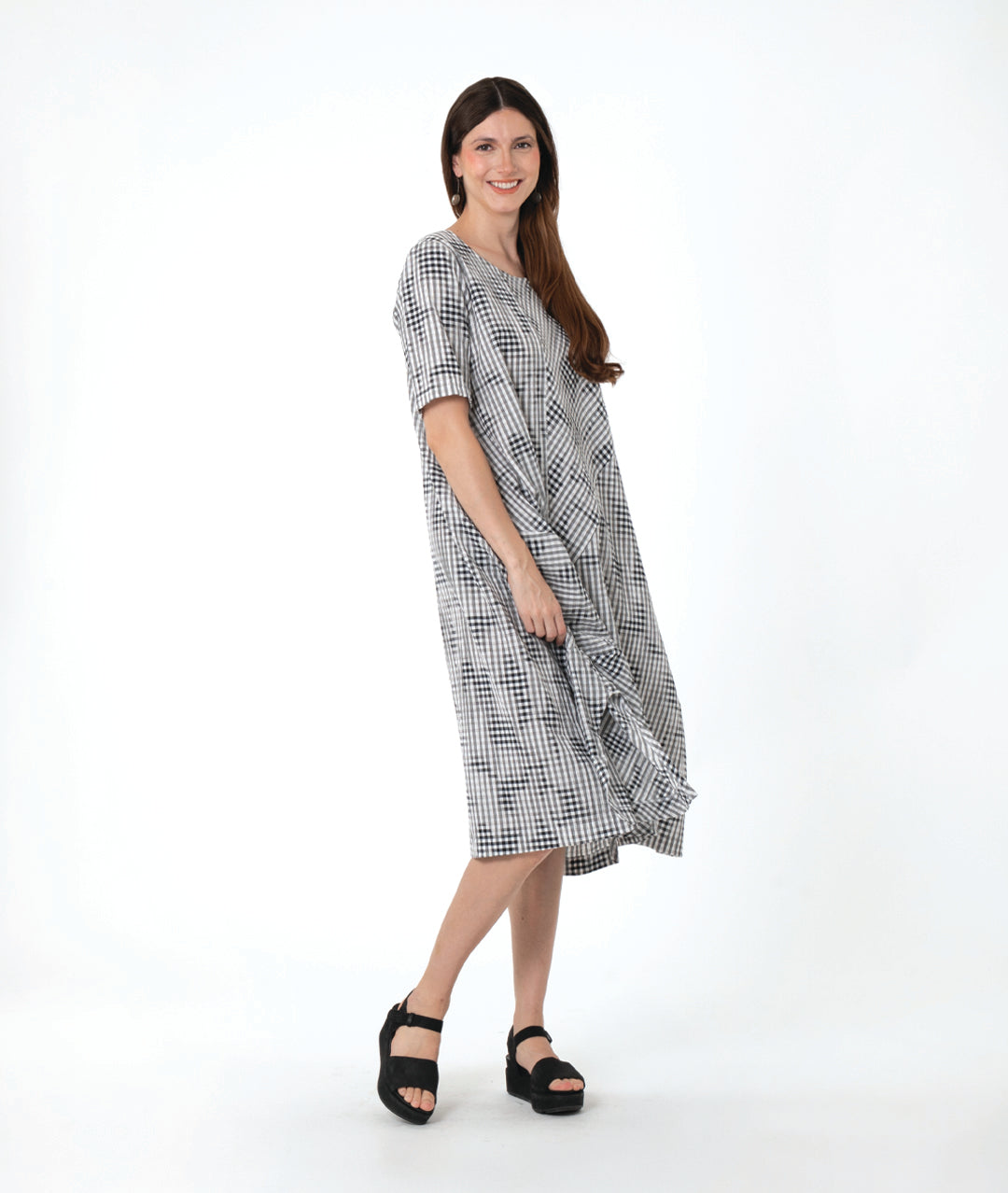 model in a grey plaid dress with asymmetrical tucks and panels