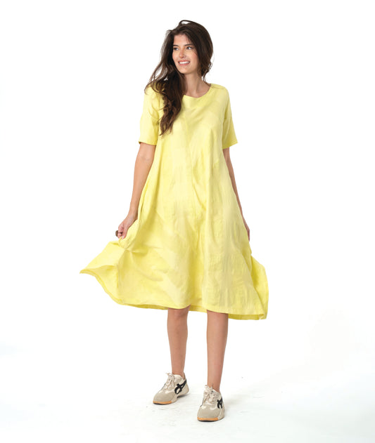 model in a large scale yellow check dress with contrasting angles and short sleeves