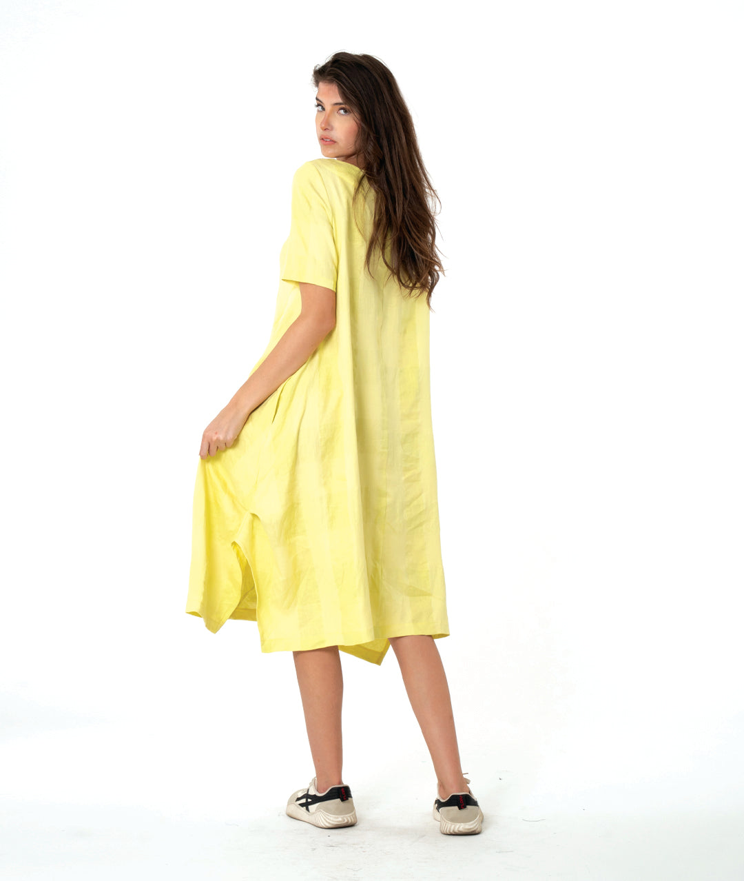 model in a large scale yellow check dress with contrasting angles and short sleeves